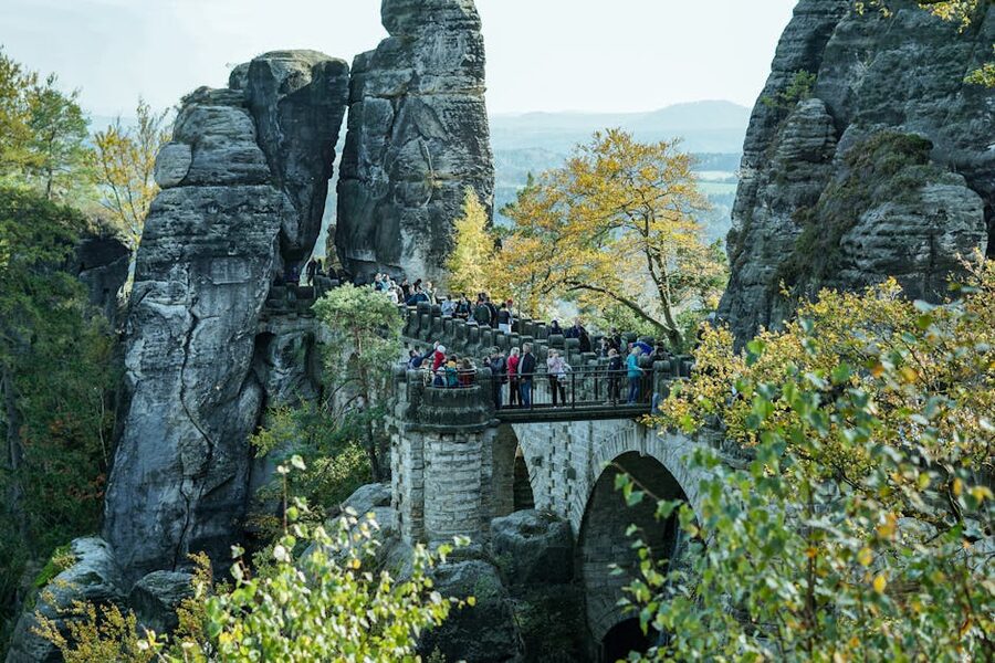 Visitors crossing iconic Bastei Bridge in autumn