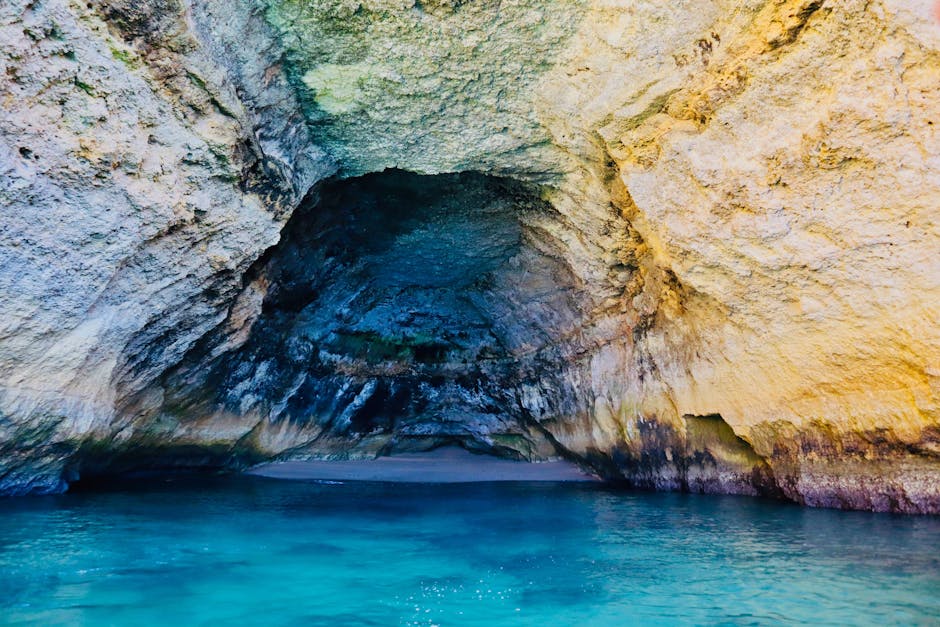 Turquoise water inside a sea cave along the Algarve coast