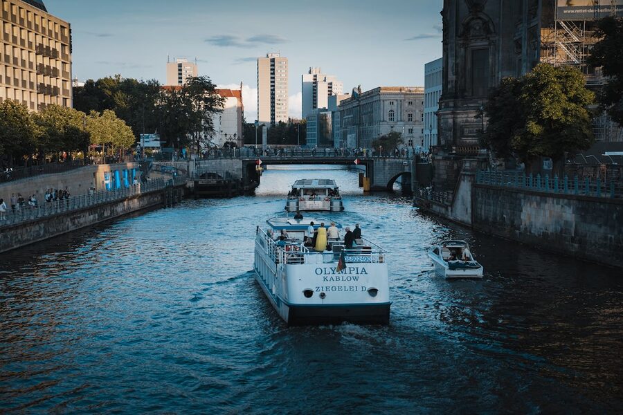 Berlin canal with boats and modern architecture