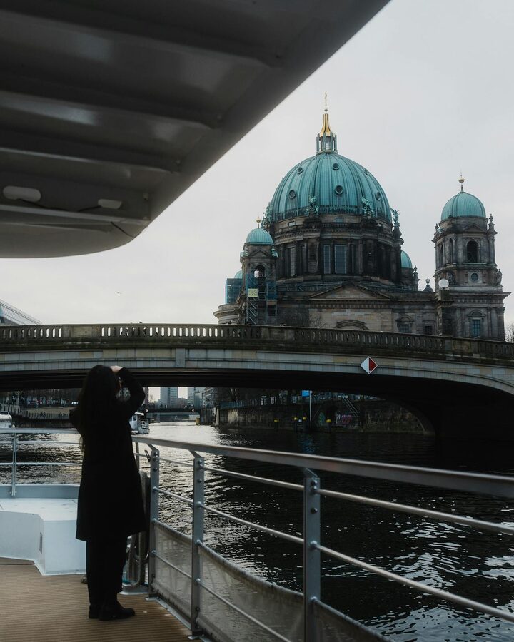 Berlin Cathedral photographed from boat under a bridge