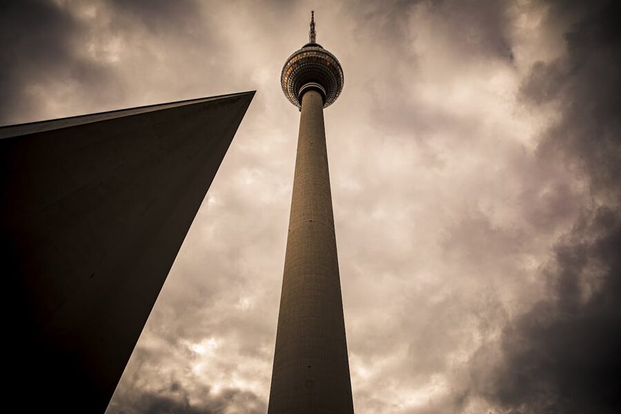 Berlin Fernsehturm from below against cloudy sky