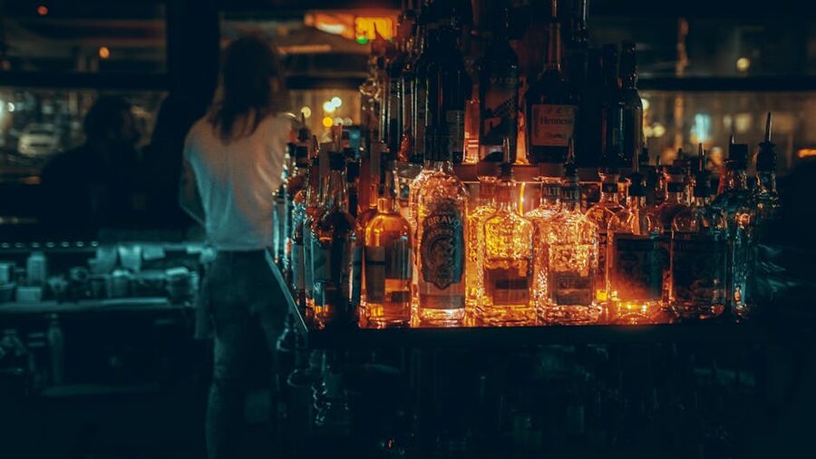 Warm moody bar interior with glowing bottles