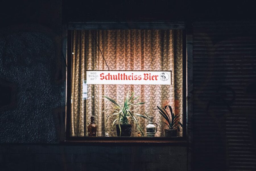Illuminated Berlin pub window at night