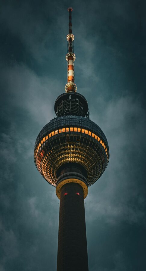 Berlin TV Tower at night under moody sky