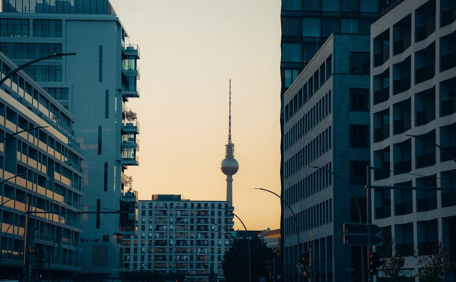 Berlin TV Tower at sunset between modern buildings