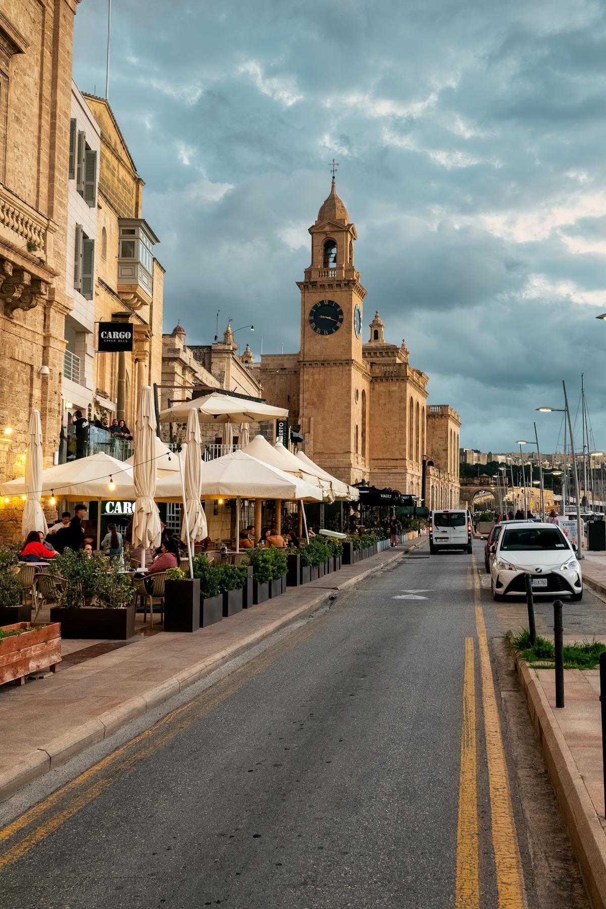 Vibrant street in the Three Cities with historic architecture and outdoor cafes
