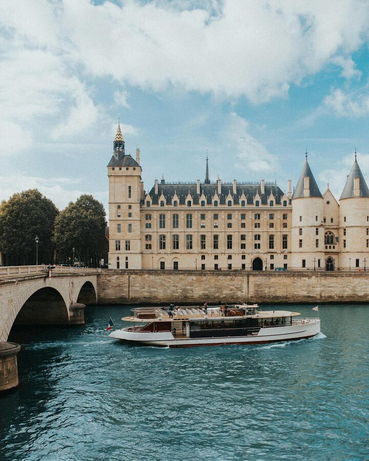 Boat cruising by the Seine with Conciergerie in Paris