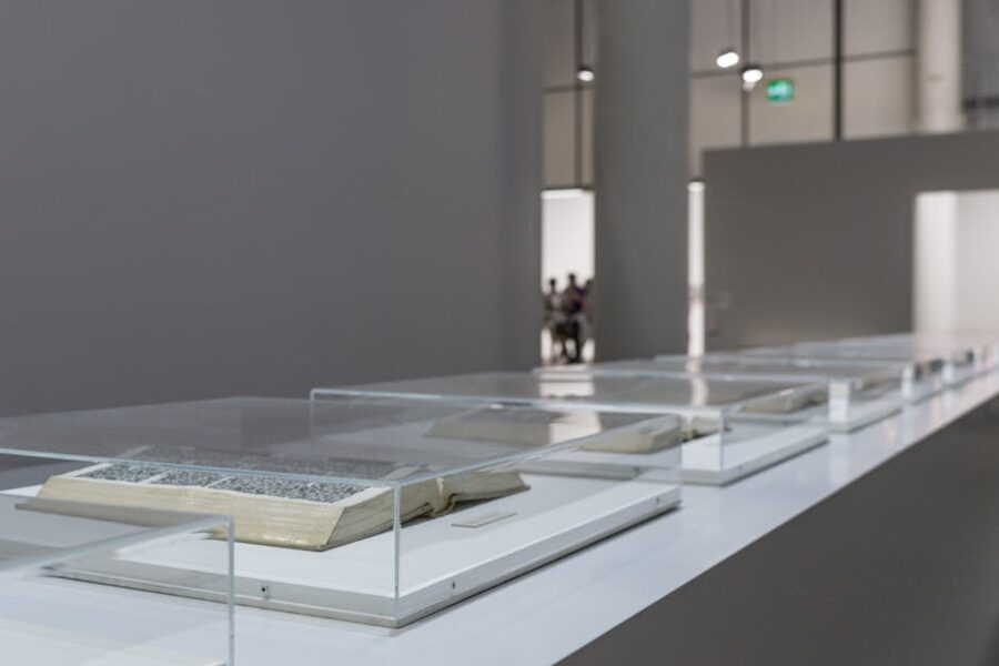 Modern art museum exhibit with open books