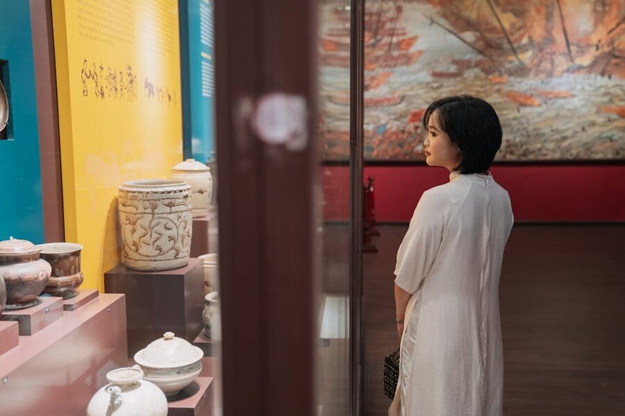 Woman engaging with historical artifacts museum