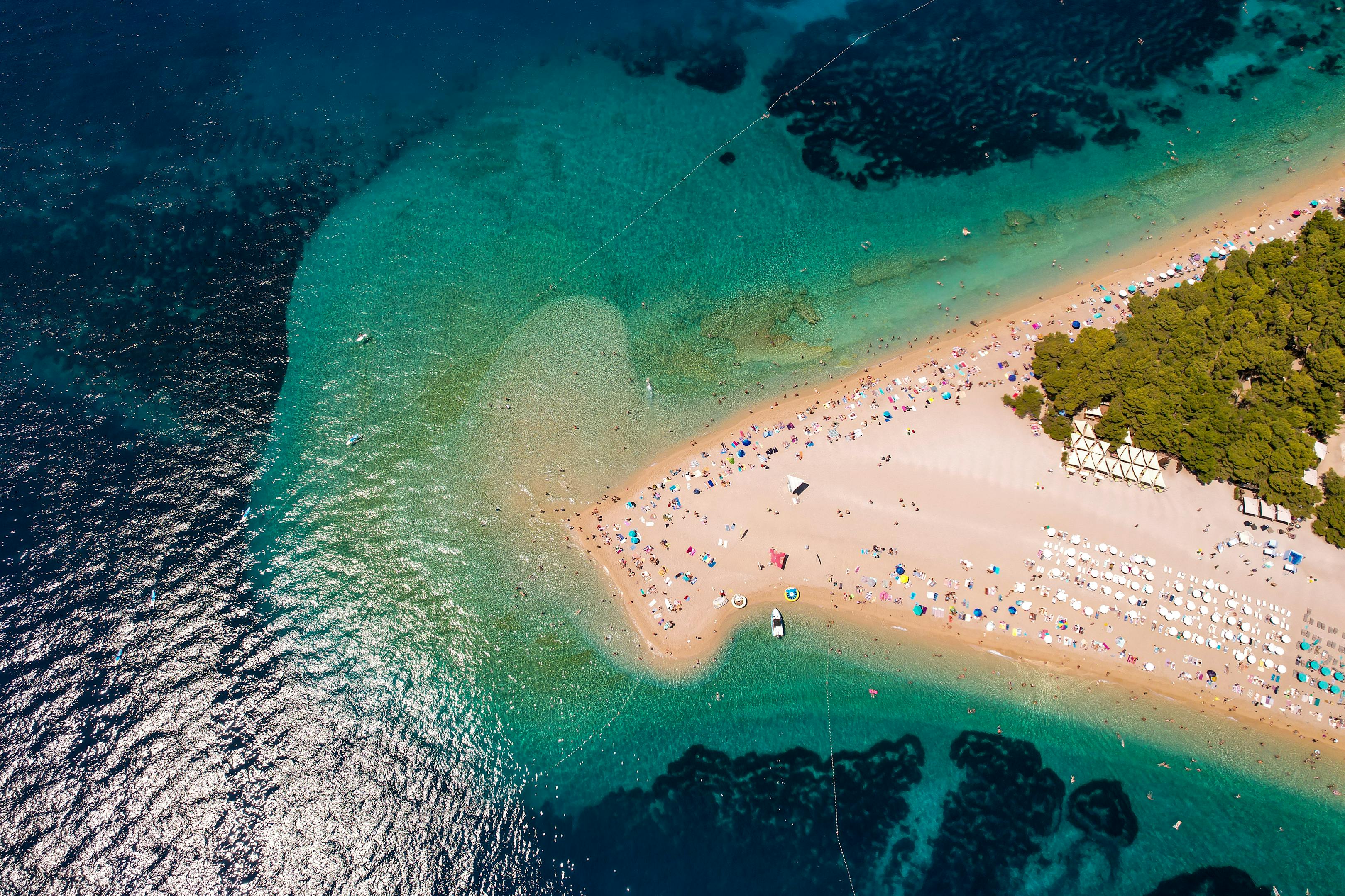 Discover the stunning Zlatni Rat beach on a sunny summer day with crystal-clear turquoise waters