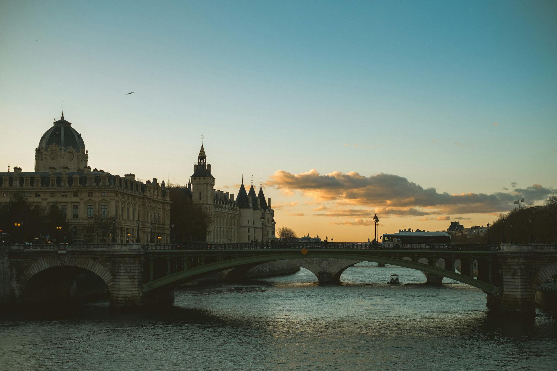 A bridge over the Seine river in Paris at sunset