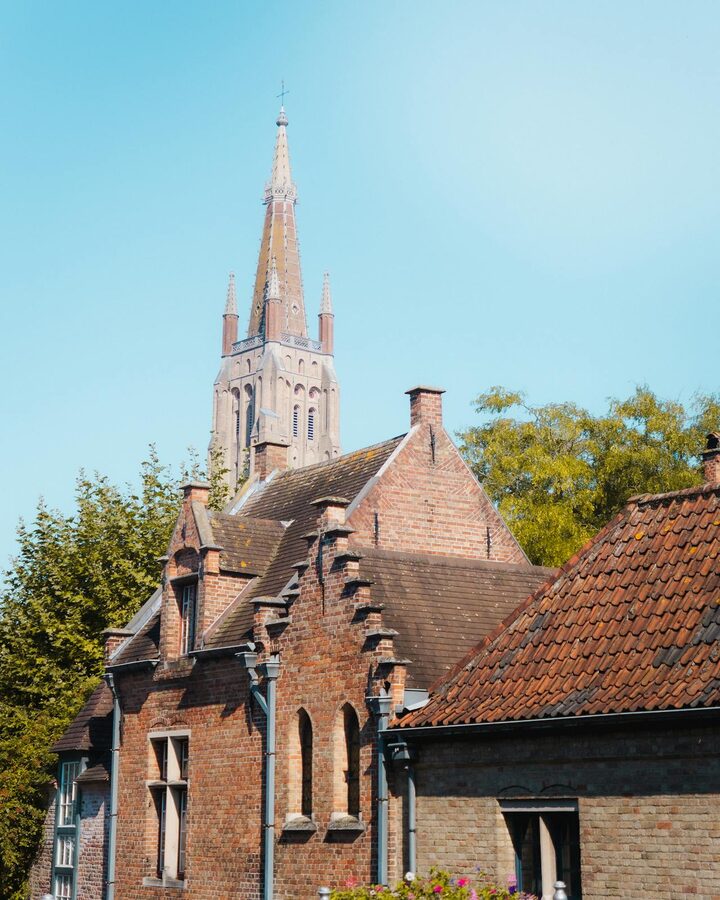 Gothic architecture against clear blue sky in Bruges Belgium