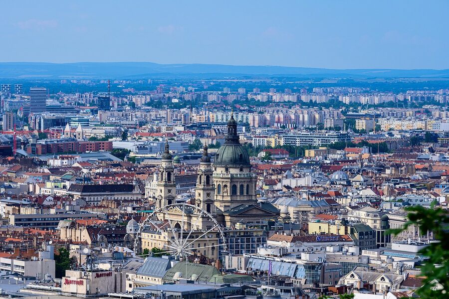 Panoramic view of Budapest cityscape from an elevated viewpoint showing rooftops and the Danube