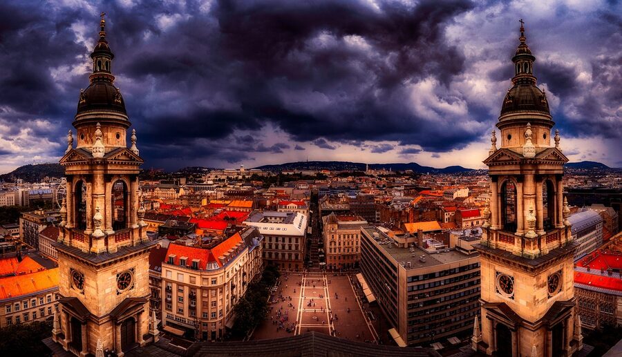 Budapest skyline at dusk with the dome of St Stephens Basilica rising above the rooftops