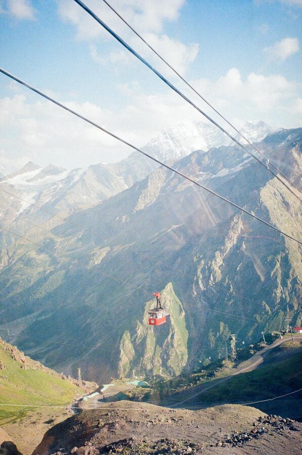 Cable car ascending with mountain panorama