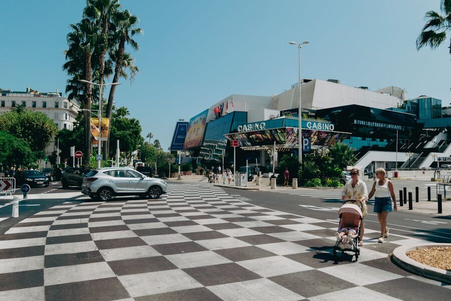 Cannes promenade featuring casino and palm trees during daytime