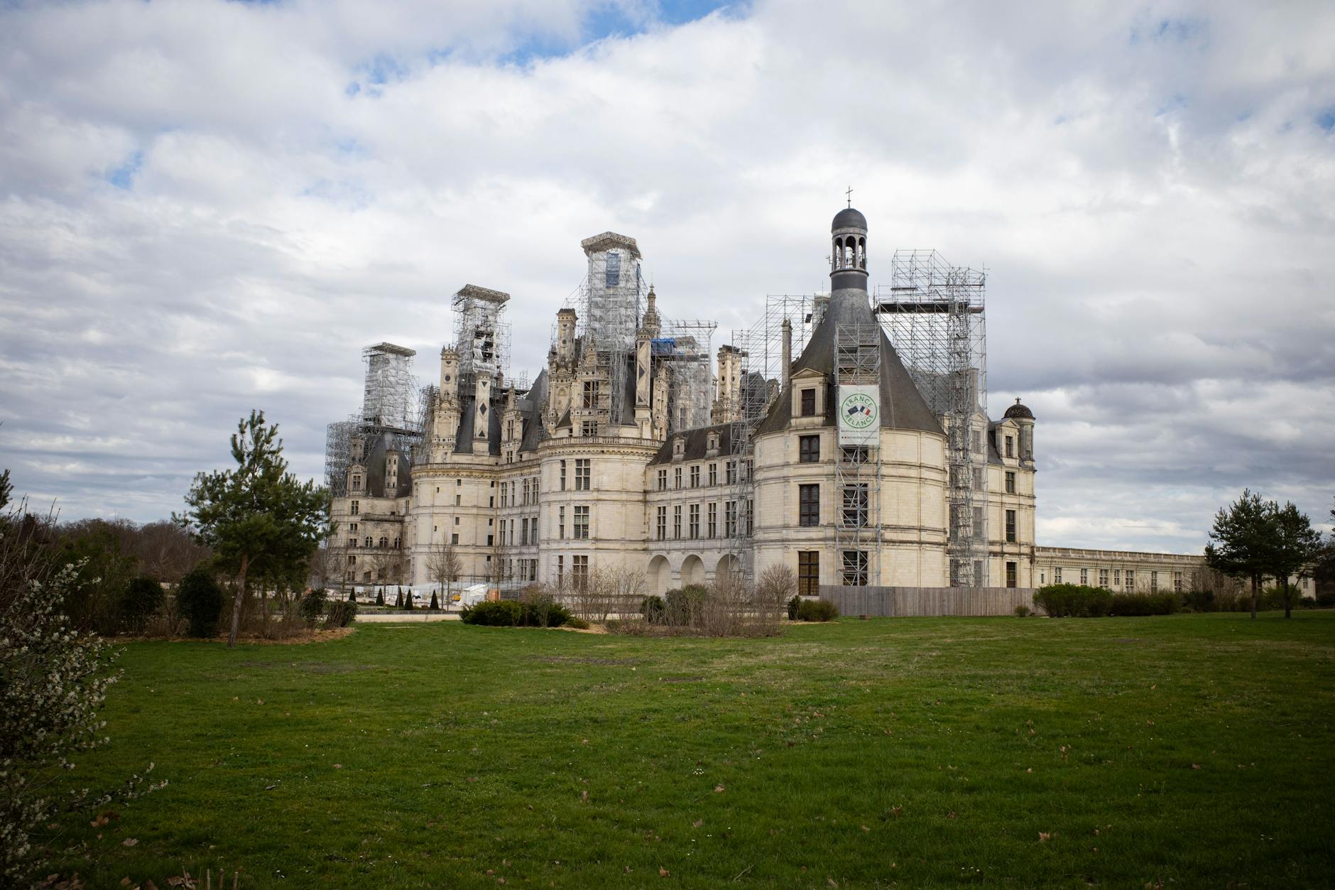 Château de Chambord in France with picturesque clouds and green lawns