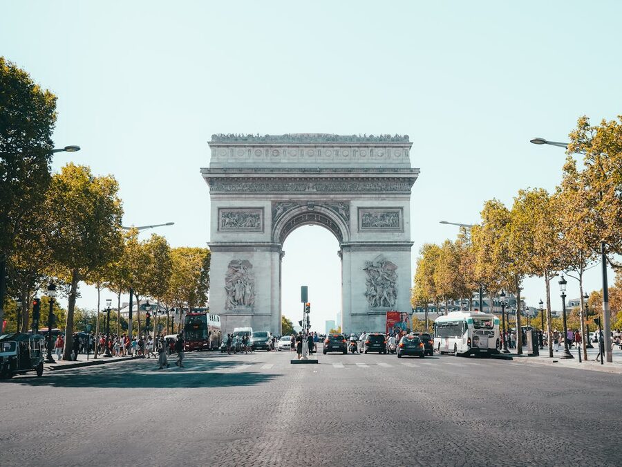 View of Arc de Triomphe from Champs-Elysees with traffic and trees
