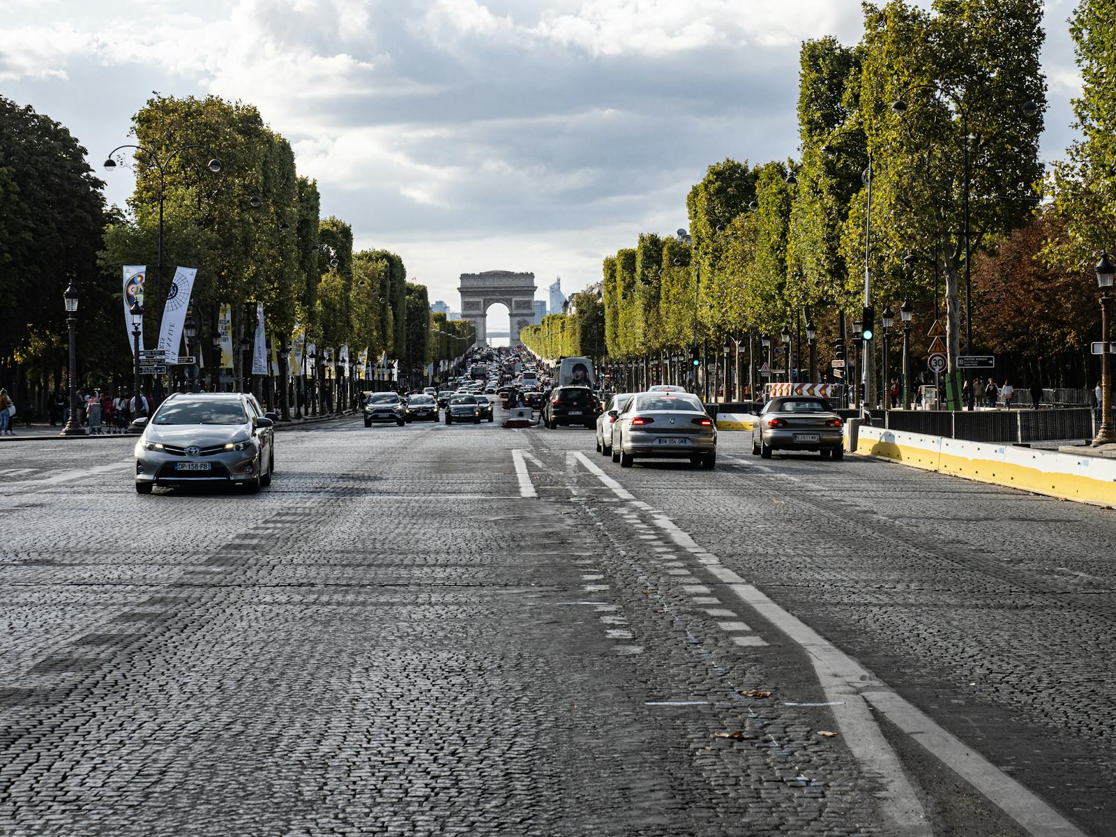 View of the busy Champs-Élysées leading to the Arc de Triomphe in Paris