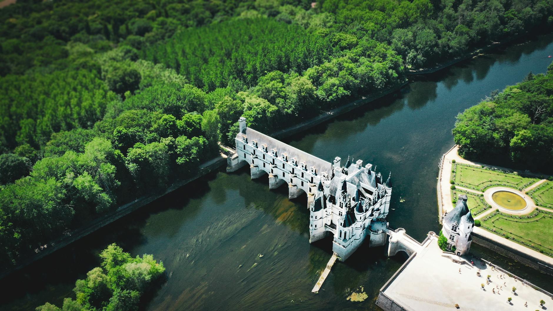 Aerial view of Château de Chenonceau surrounded by lush greenery