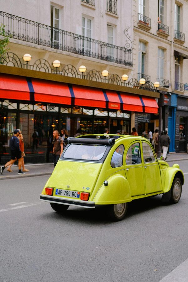 Citroen 2CV cruising an urban Paris street