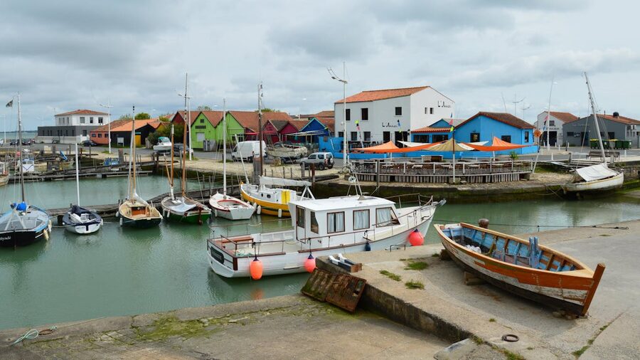 Colourful coastal town with boats moored at the marina