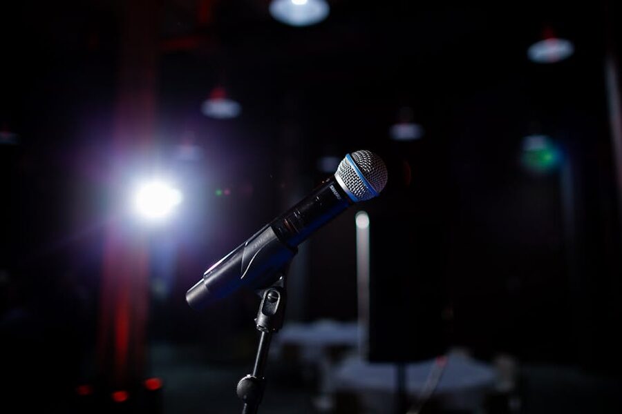 Microphone on stage under spotlight at comedy venue