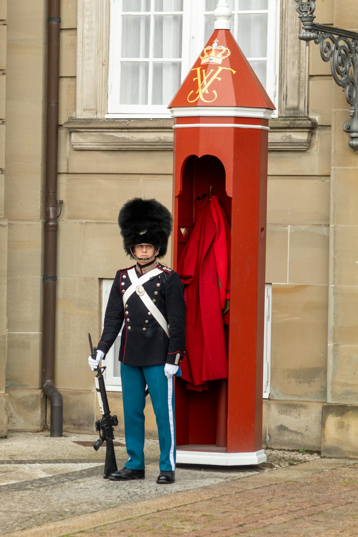 Royal Guard in traditional uniform standing at attention at Amalienborg Palace, Copenhagen