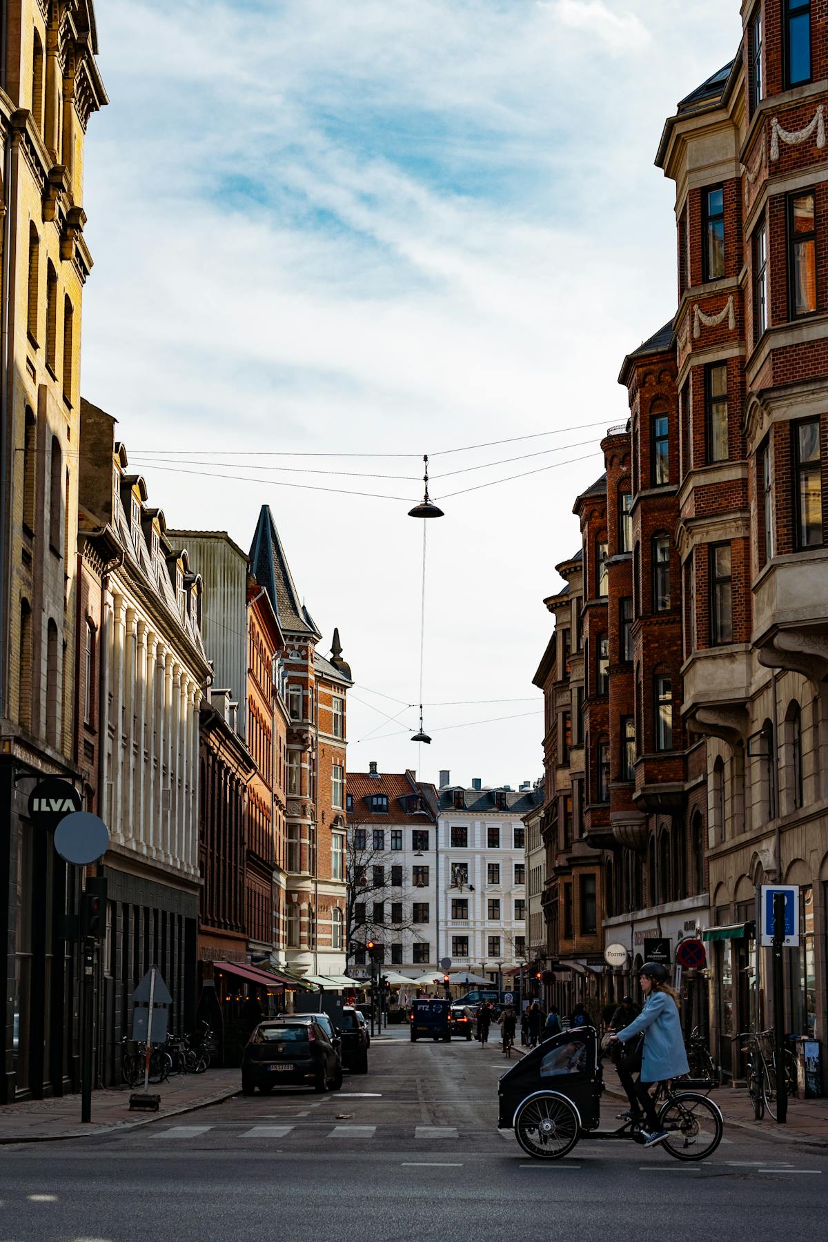 Bustling street in Copenhagen with classic architecture and cyclist