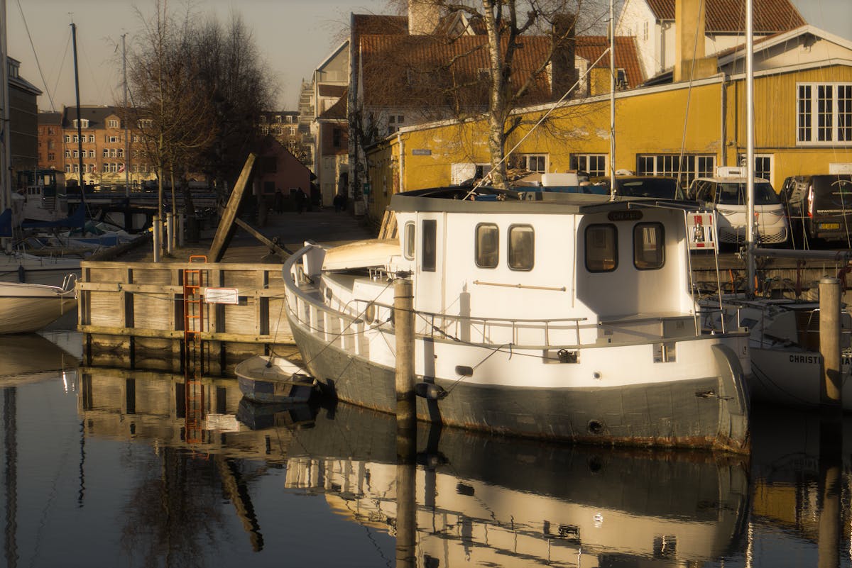 Copenhagen canal with boats reflecting during a golden sunset