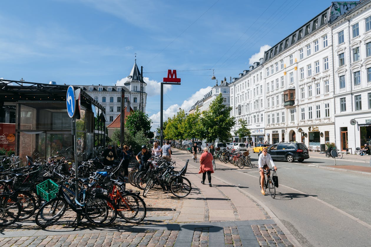 Bicyclists and pedestrians on a lively Copenhagen street showcasing urban cycling culture