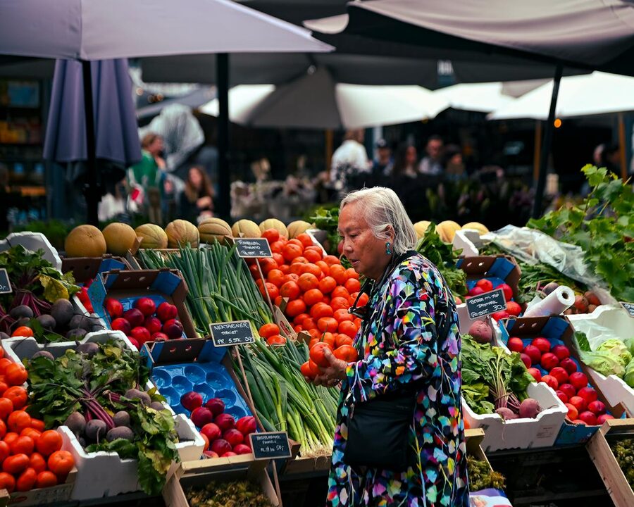 Vibrant market in Copenhagen with fresh produce on display at colourful stalls