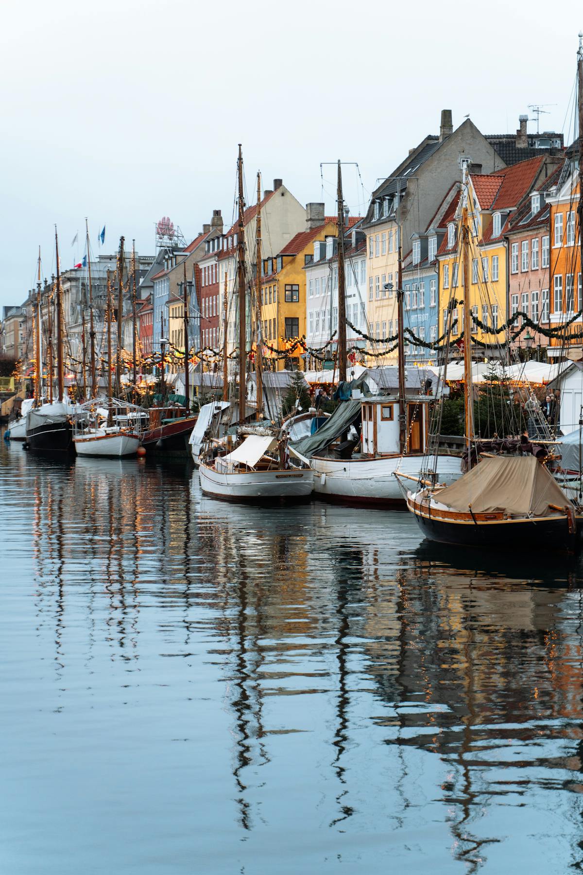 Nyhavn canal in Copenhagen with colourful houses and sailing boats on a summer day