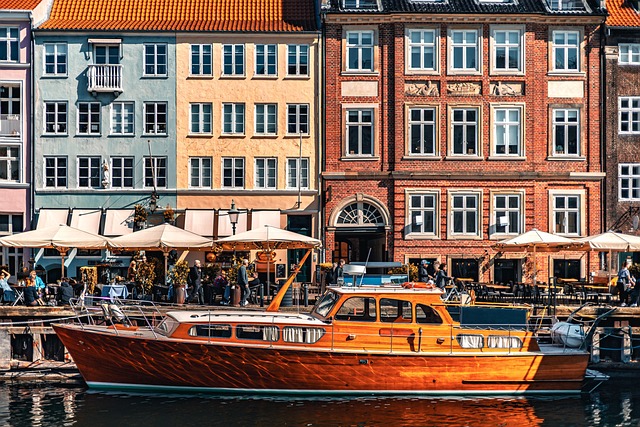 Panoramic view of Nyhavn colourful townhouses and boats along the canal