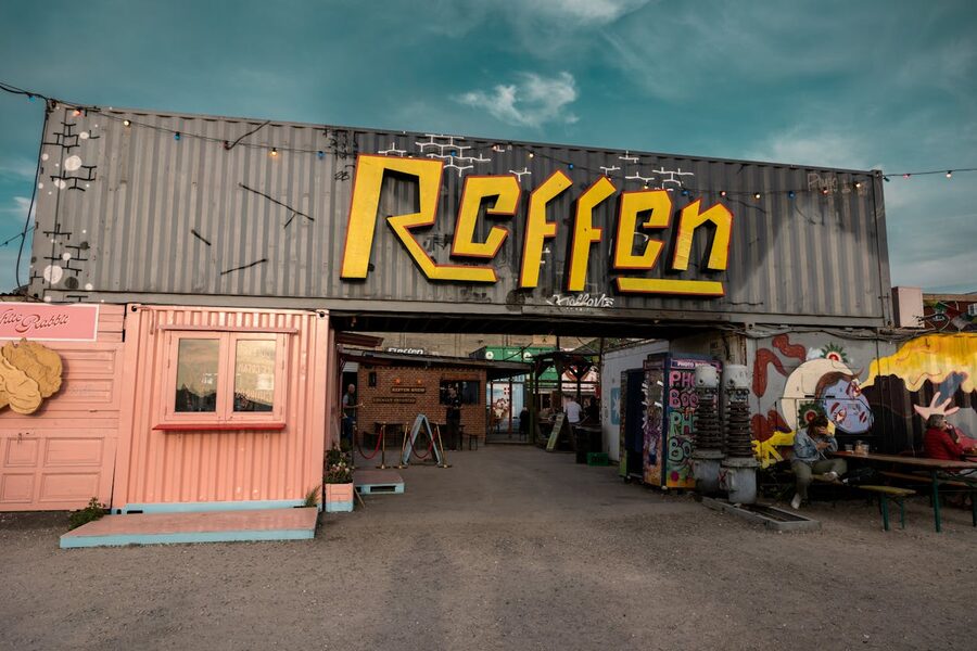 Lively atmosphere of Reffen street food market in Copenhagen with vibrant street art and food stalls