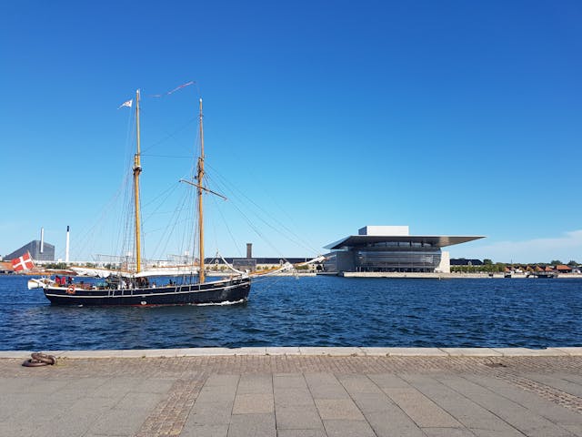 Traditional sailing ship passing by the Copenhagen Opera House
