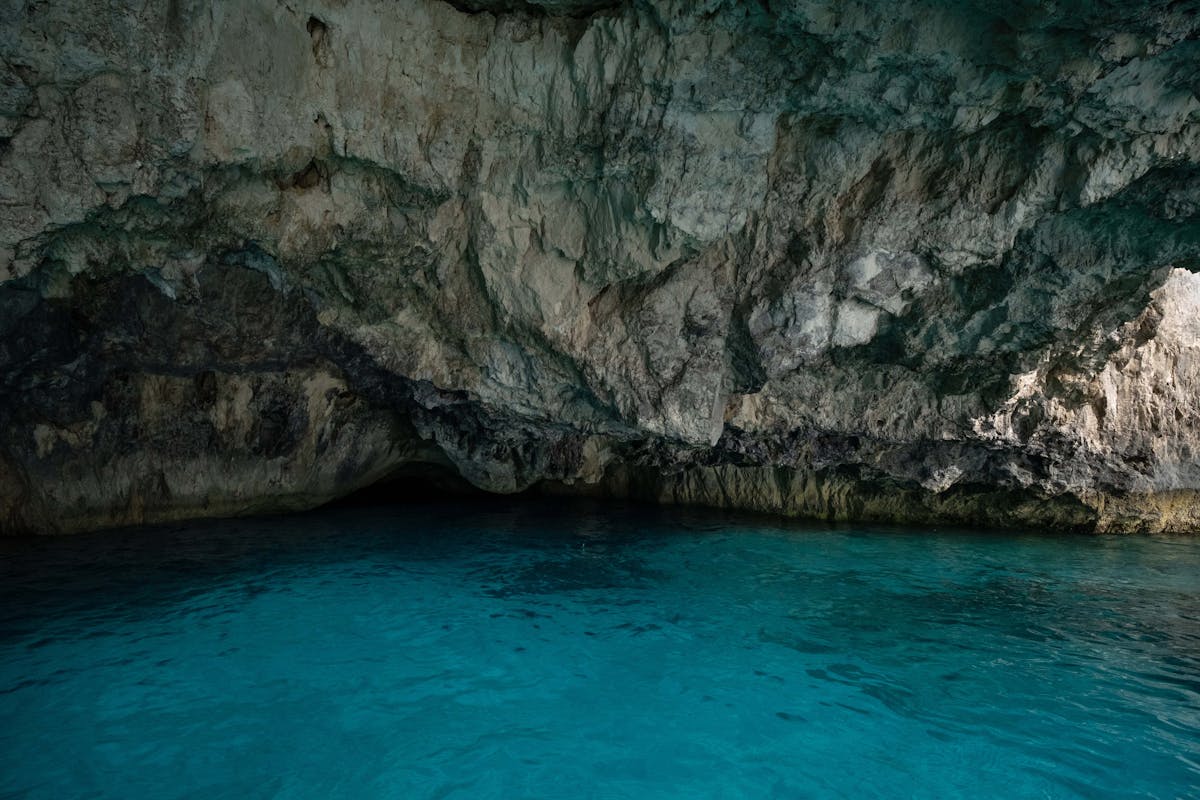 Interior of a natural sea cave with blue water