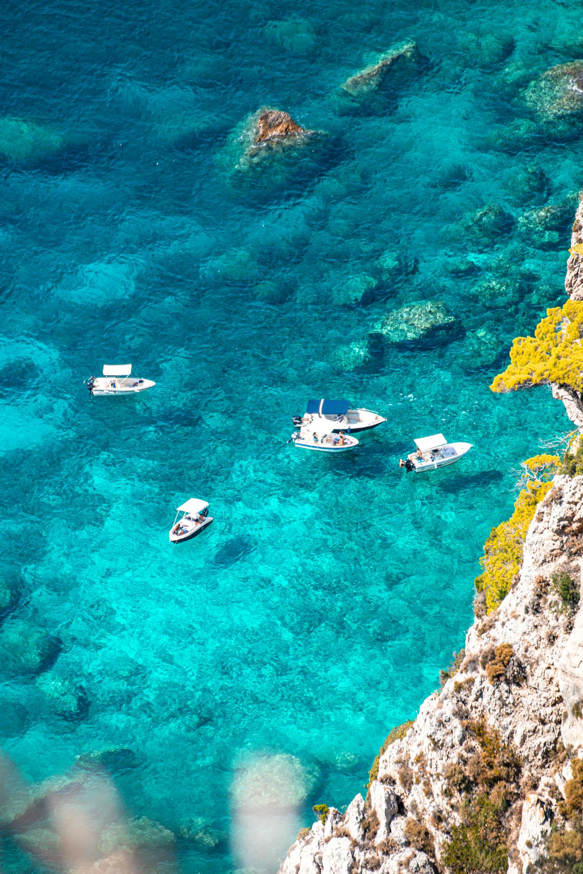 Boats on crystal-clear turquoise waters near Paleokastritsa, Corfu