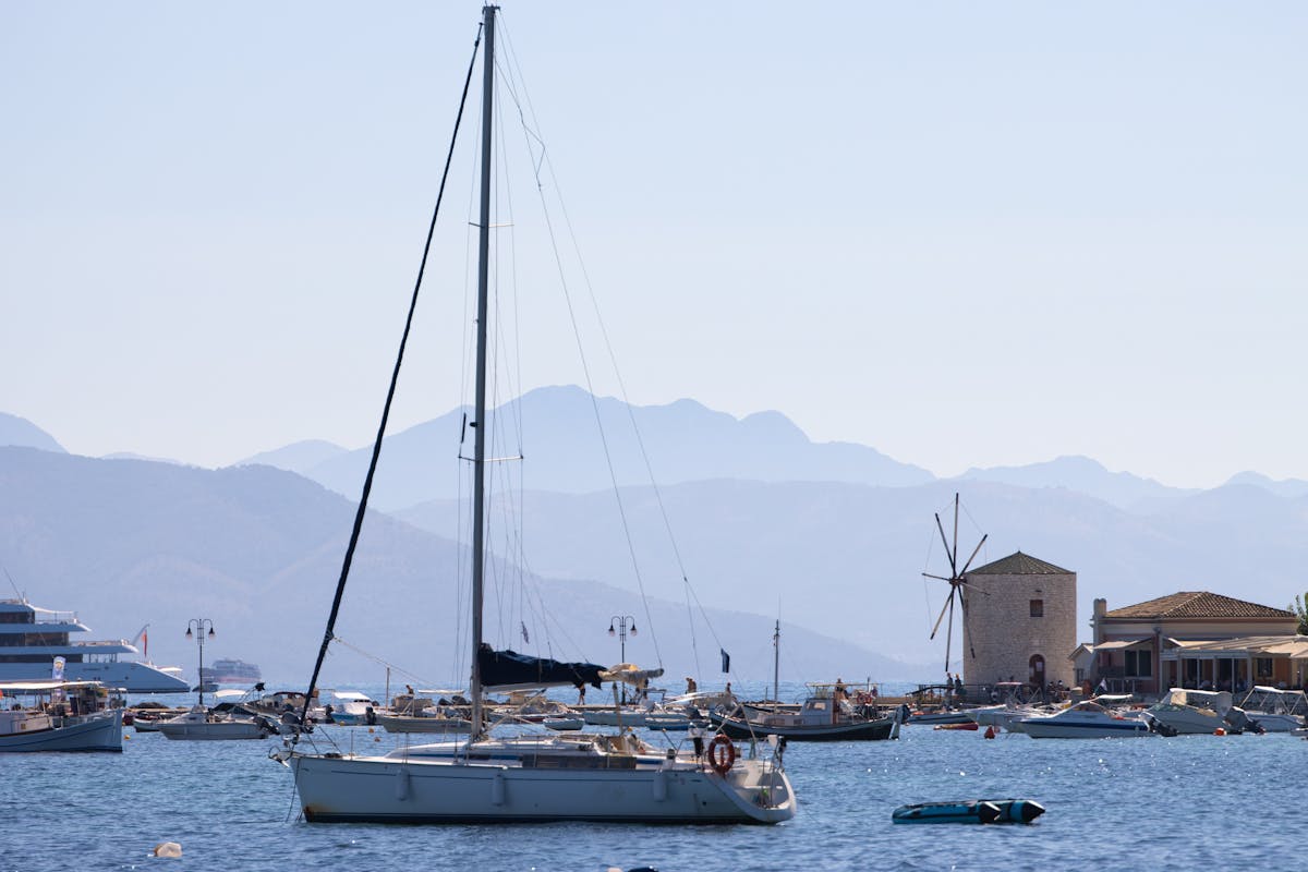 Traditional boats in Corfu harbour with windmill