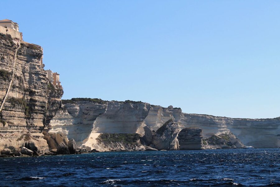 Corsica coast with limestone cliffs meeting turquoise sea