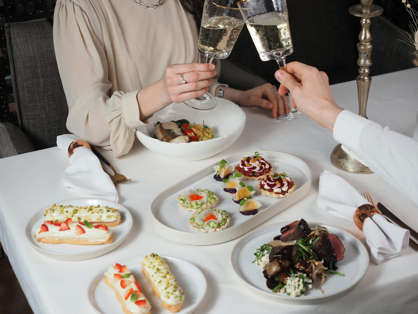 Couple toasting with champagne glasses during an elegant dinner