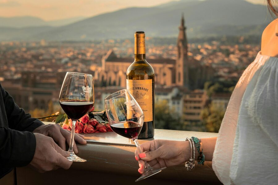 Couple enjoying wine toast with Florence sunset view