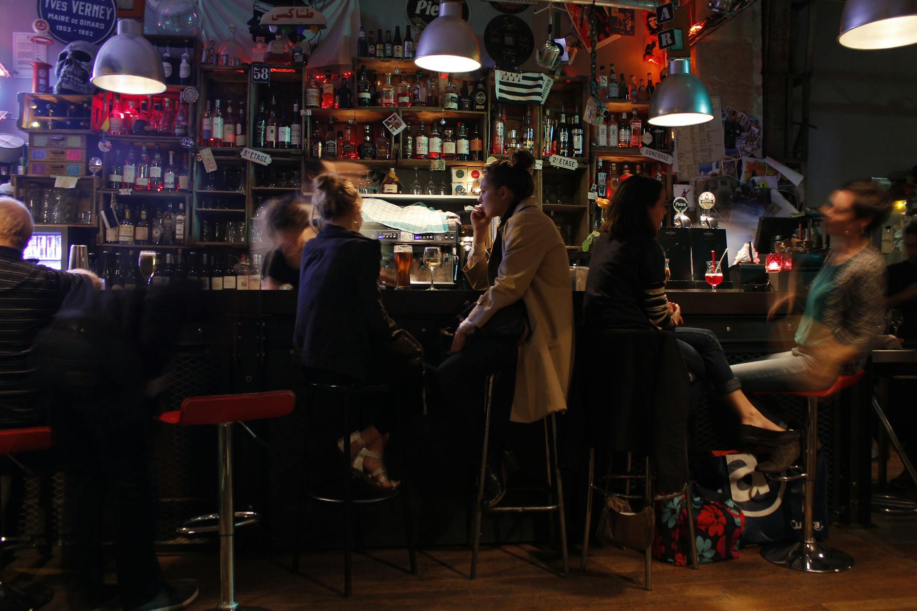 Cozy Parisian bar scene at night with people enjoying drinks