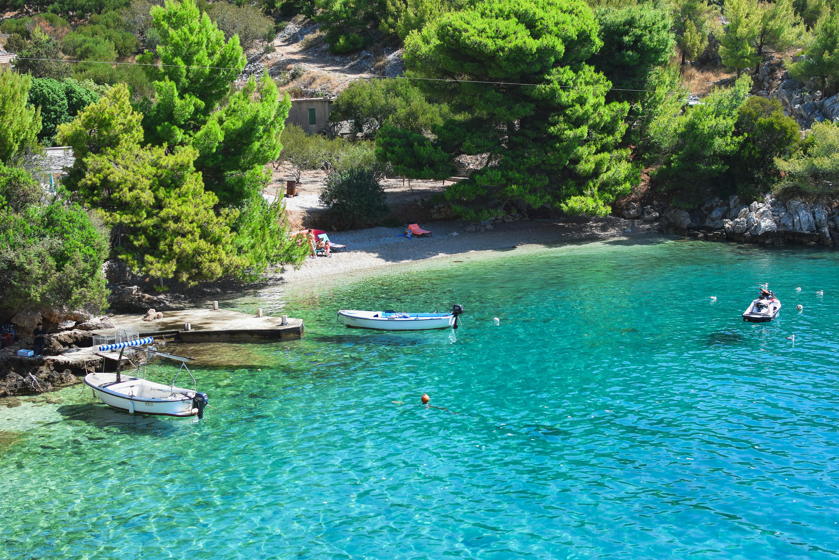 Discover tranquility in a secluded Croatian cove with clear turquoise water, perfect for summer relaxation