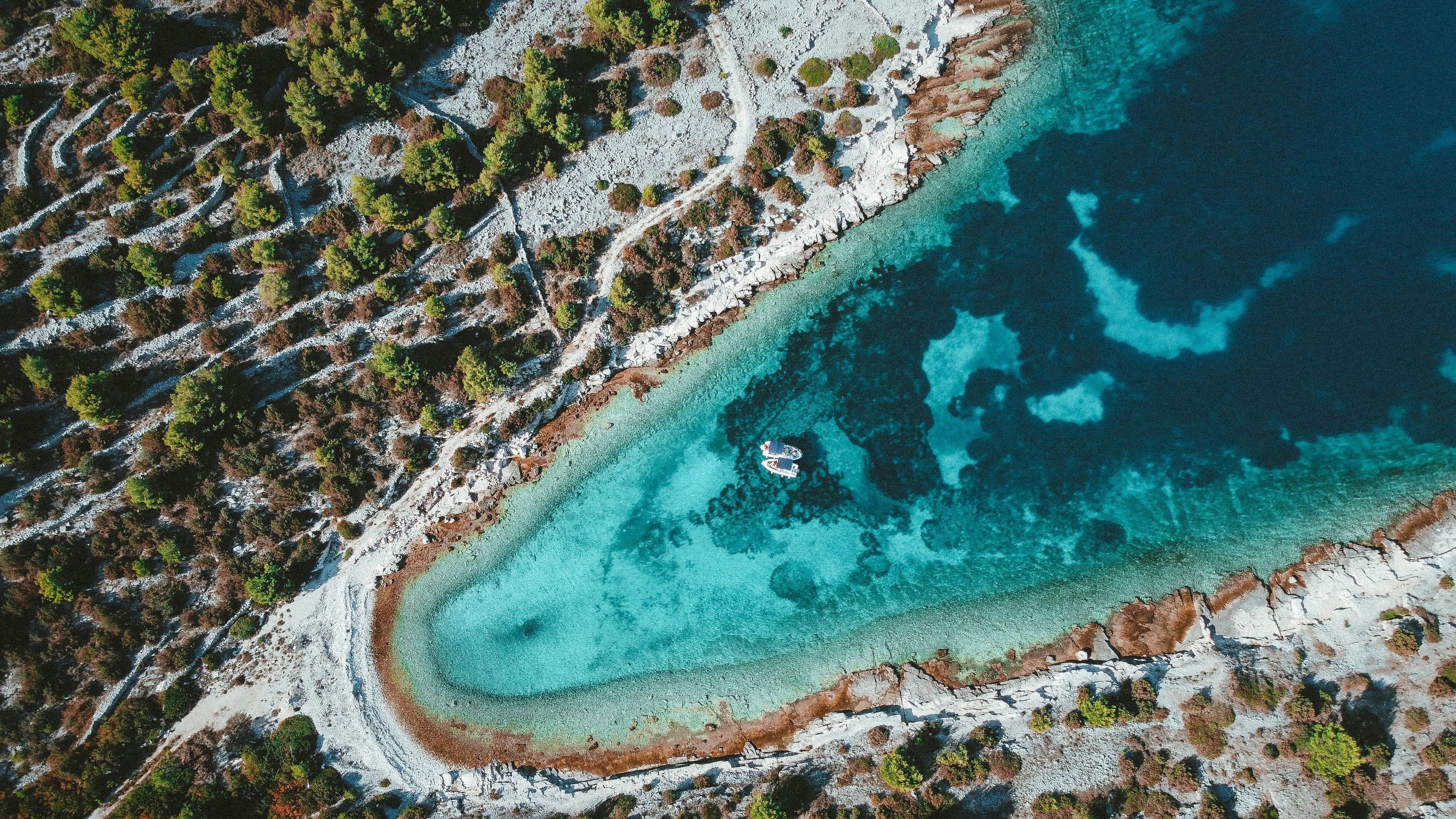 Aerial shot capturing Croatia's stunning turquoise coast and rocky shoreline