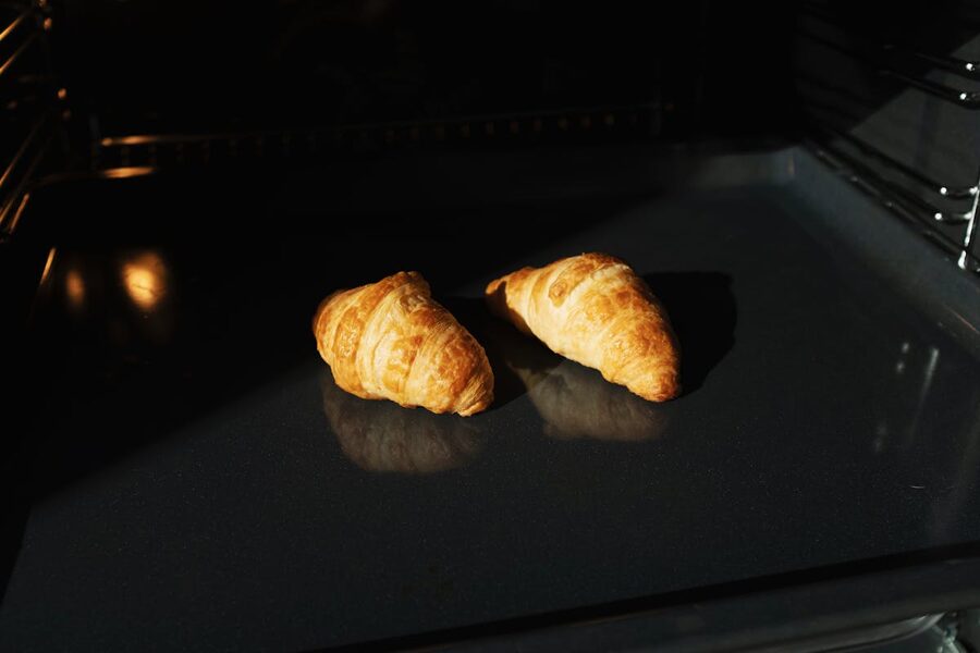 Golden croissants baking in an oven
