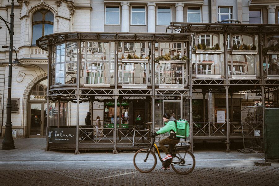Cyclist passing architectural landmarks