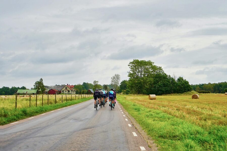Cyclists on leisure ride through green fields
