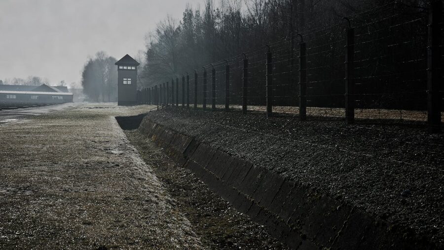 Barbed wire fence and watchtower at Dachau