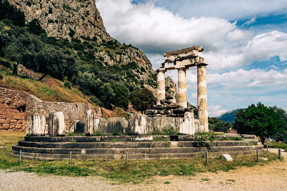 Ancient temple ruins of Delphi against a mountainous backdrop